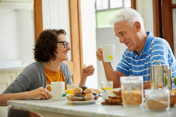 istock Retired couple enjoying breakfast at dining table 1198077191
