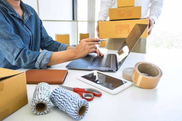 istock Young business owner work at home receive order customer and take note list with report and packing the product order delivery online to sending destination, Online business and delivery concept 1198080816