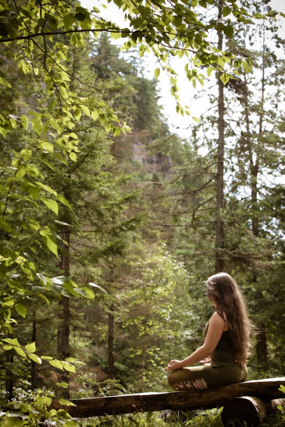 istock Young Woman Relaxing And Meditating In Nature 1198082196