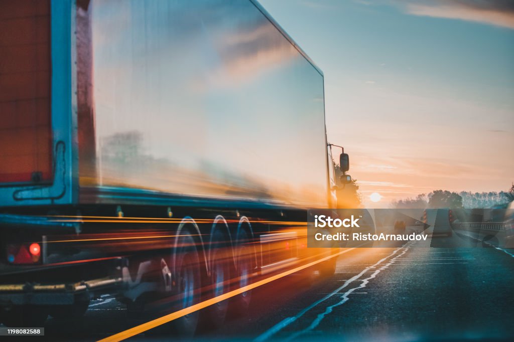 Lorry on motorway in motion Red Lorry on M1 motorway in motion near London Freight Transportation Stock Photo