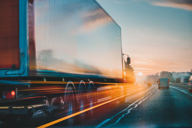 Lorry on motorway in motion Red Lorry on M1 motorway in motion near London thoroughfare photos stock pictures, royalty-free photos & images