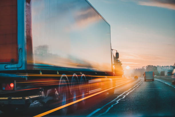 Lorry on motorway in motion Red Lorry on M1 motorway in motion near London shipping stock pictures, royalty-free photos & images