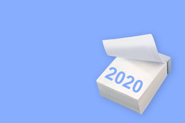 istock Paper calendar and 2020 on blue background 1198085802