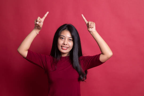 istock Young Asian woman point to blank space. 1198085851