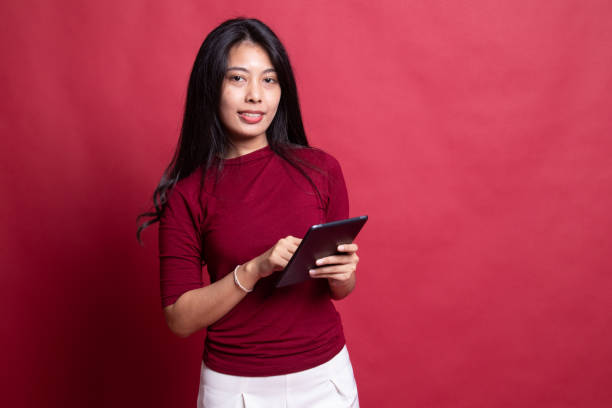 istock Young Asian woman with a computer tablet. 1198085871