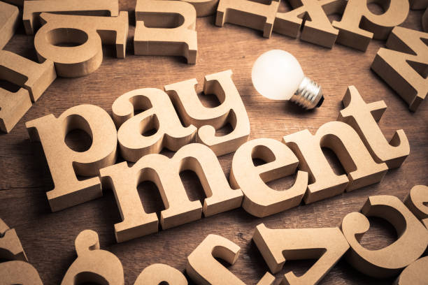 istock Payment wood word 1198086945