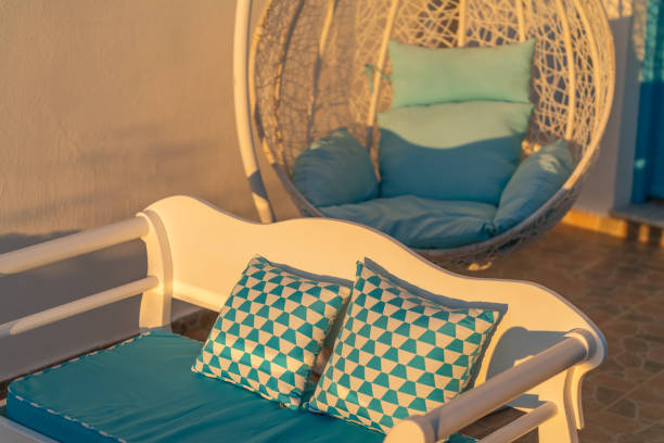Terrace with two form of chair in golden glow of morning sun.
