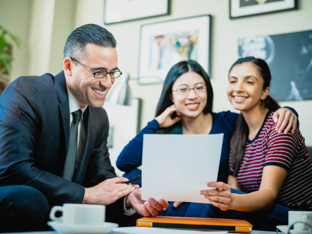 istock Financial advisor talking to Lesbian couple 1198089524