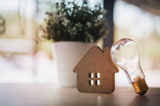 istock Wood house with Light bulb on the table, a symbol for construction, Creative light bulb idea, power energy or business idea concept ecology, loan, mortgage, property or home. 1198089633