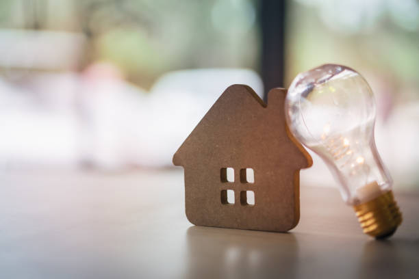 istock Wood house with Light bulb on the table, a symbol for construction, Creative light bulb idea, power energy or business idea concept ecology, loan, mortgage, property or home. 1198089653