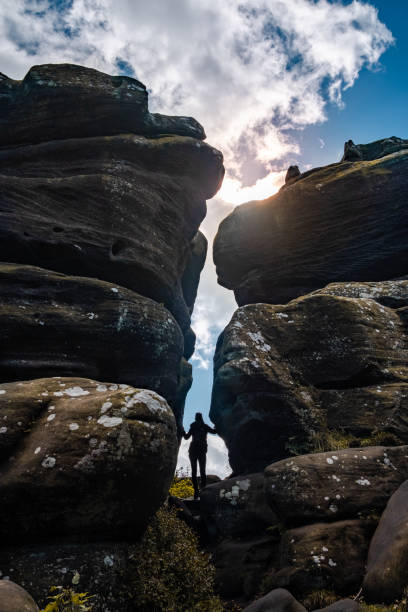 istock Girl standing between rocks 1198089817