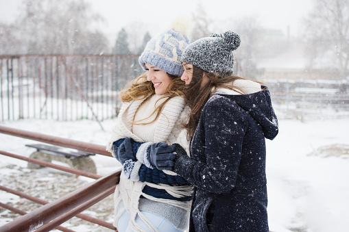 Two girls walk on a snowy day