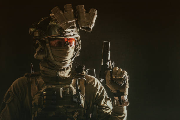 istock Combatant armed with service pistol in darkness 1198089992