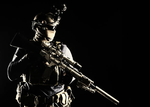 istock Army marksman with sniper rifle in darkness 1198090273