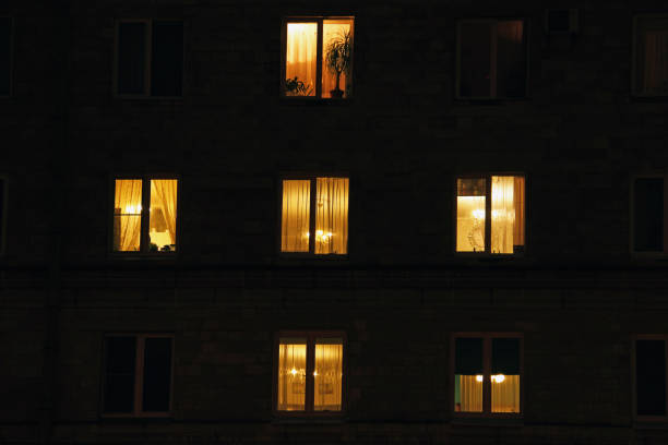 Lighted night windows of houses stock photo