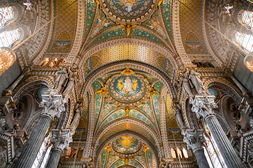 Majestic interior of the Basilica Notre Dame de Fourviere built between 1872 and 1884 with Byzantine and Romanesque architecture style, in a dominant position overlooking the city of Lyon, and dedicated to the Virgin Mary. It features fine mosaics and superb stained glass very ornate with gold and some paintings on the ceiling. This image was taken inside this famous place of worship monument in Lyon city, in Rhone department, Auvergne-Rhone-Alpes region in France (Europe), on Fourviere hill.