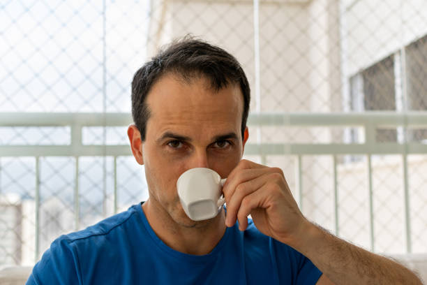 istock Man having a cup of coffee and looking at camera. 1198092628