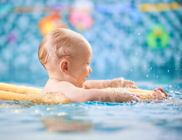 istock Baby having fun in the swimming pool 1198092932