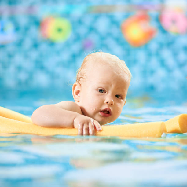 istock Baby having fun in the swimming pool 1198092935