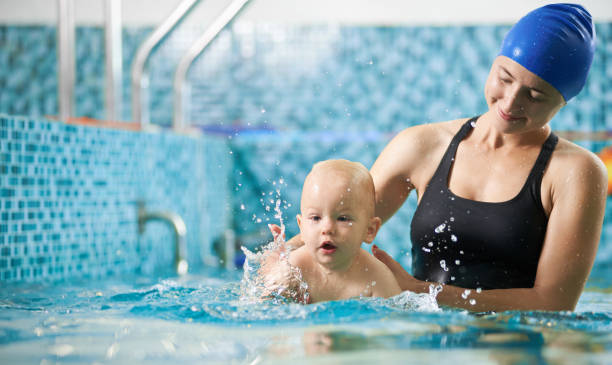 istock Mother with baby boy in swimming pool training 1198092950