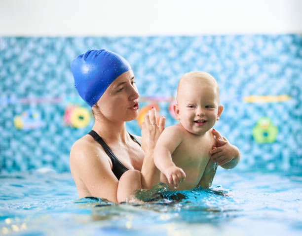 istock Mother with baby boy in swimming pool training 1198092951