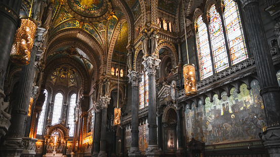 Majestic interior of the Basilica Notre Dame de Fourviere built between 1872 and 1884 with Byzantine and Romanesque architecture style, in a dominant position overlooking the city of Lyon, and dedicated to the Virgin Mary. It features fine mosaics and superb stained glass very ornate with gold and some paintings on the ceiling. This image was taken inside this famous place of worship monument in Lyon city, in Rhone department, Auvergne-Rhone-Alpes region in France (Europe), on Fourviere hill.