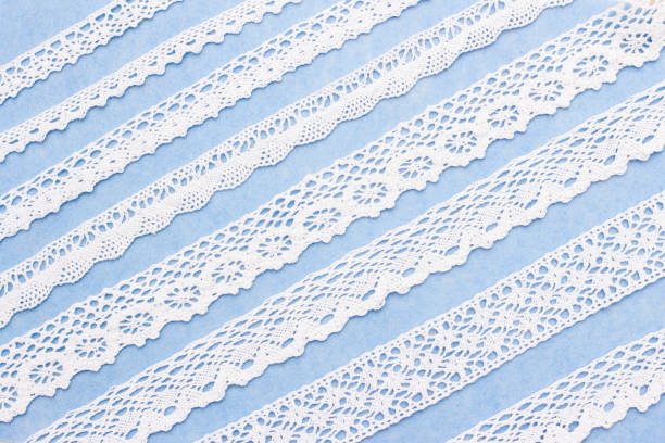 istock abstract background. white lace on a blue background. Lace of different widths. studio 1198093725