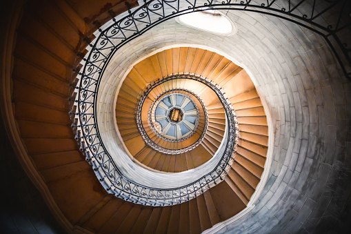 Awesome large spiral staircase seen from below inside one of the beautiful bell towers of the Basilica Notre Dame de Fourviere in Lyon French city