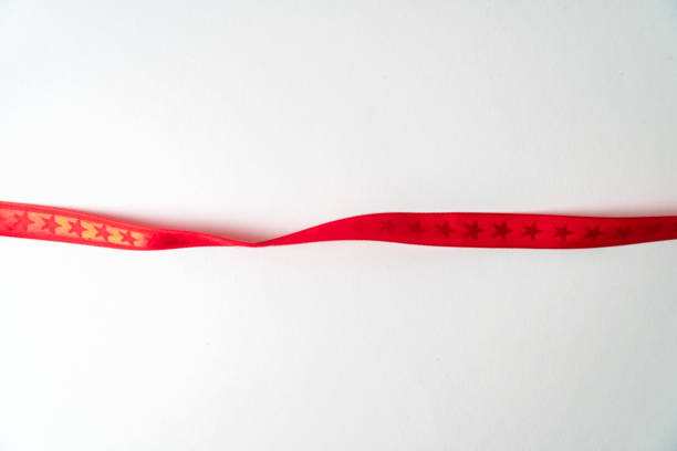 istock A red ribbon with stars building a frame on white background 1198095359