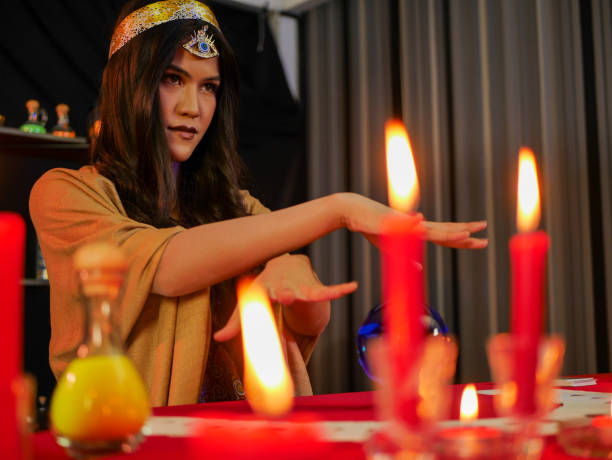 istock Asian​ Lady​ Fortune telling using​ tarot​ card​ and crystal​ ​ball​ and Magic Power filter for girl 1198097623