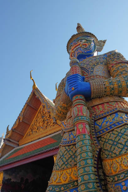 istock Patterned sculpture of a demonic warrior near a Buddhist temple. 1198098868