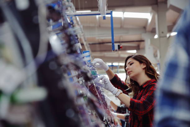 female manuel workers team working on the production line in factory - electric plug electricity women power imagens e fotografias de stock