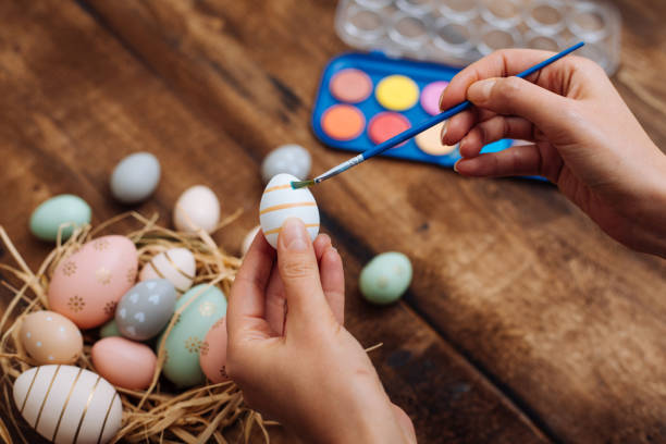 istock Woman painting easter eggs 1198101642