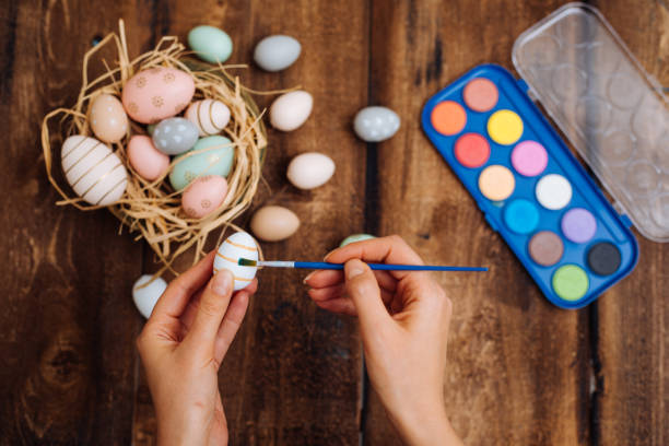istock Woman painting easter eggs 1198101659