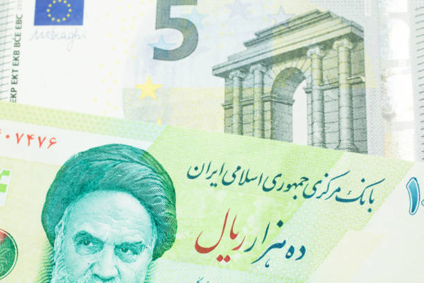 istock An Iranian rial bill with European money 1198101736