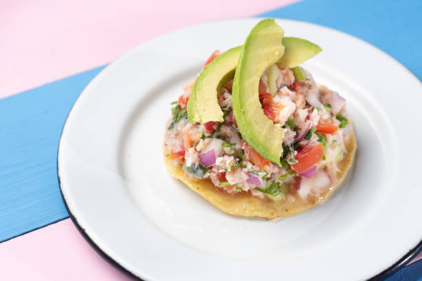 istock Mexican fish  ceviche with avocado on colorful background 1198101774