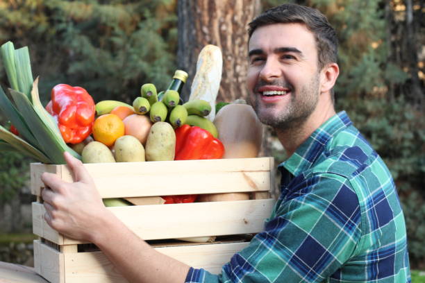 istock Cute guy holding basket with natural food 1198105206