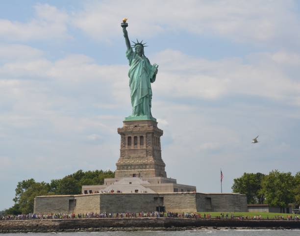 istock statue of liberty with people and seagull 1198105314