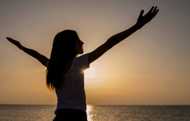 istock young girl cheering with outstretched arms 1198106603