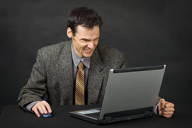 istock Furious man looks at laptop screen 119810755