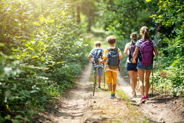 family enjoying hiking together - vacations two generation family caucasian friendship imagens e fotografias de stock