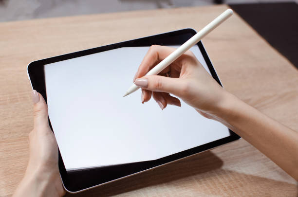 istock Girl using stylus on tablet to draw 1198107819