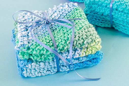 Homemade crocheted dishcloths tied up with ribbon as gifts.