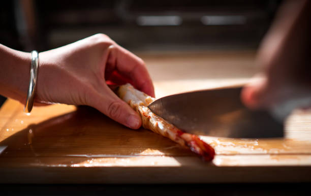 istock Person cutting a large prawn 1198109102