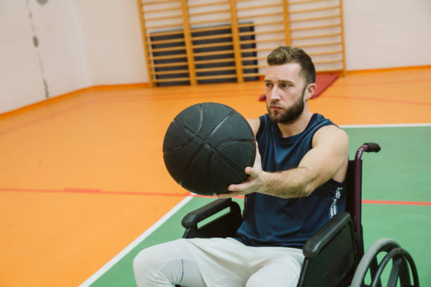 istock Man in wheelchair playing basketball 1198109357
