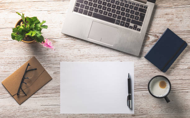 istock office desk with empty sheet of paper 1198109908