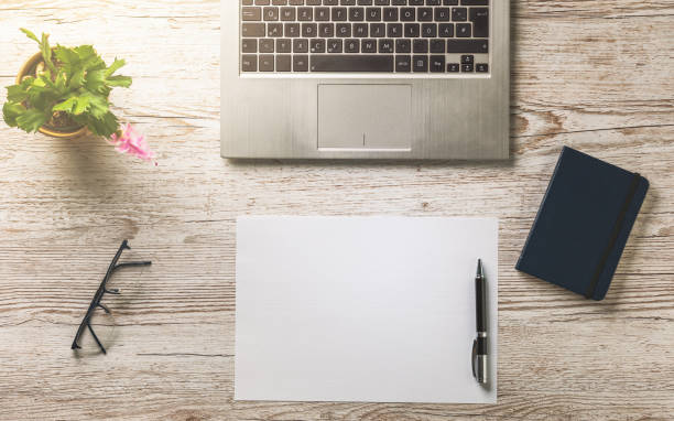istock office desk with empty sheet of paper 1198109937