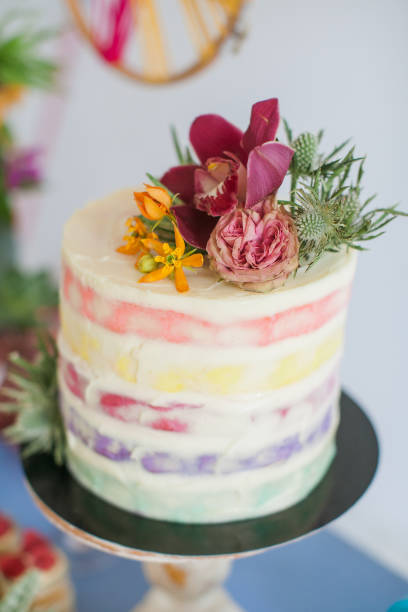 istock Cake decorated with rose, orchids and succulent. Great desserts surrounded by flowers. Boho style scenery for a sweet table for a celebration, celebration or wedding. 1198112327
