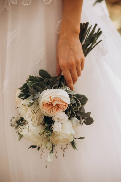 istock Bride holding wedding peonies bouquet 1198116232