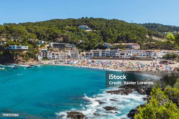 Crowded Beach In Costa Brava Summer Holidays Destination In Europe Stock Photo - Download Image Now